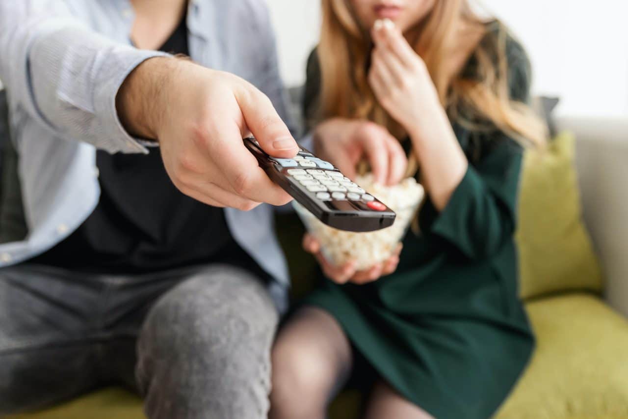A man using a TV remote.